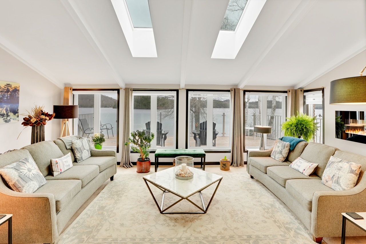 Bright sunroom and living area with skylights